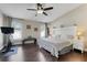 Serene bedroom with hardwood floors, neutral tones, and multiple windows offering lots of natural light at 2889 Columbus Ave, Clermont, FL 34715