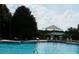A large community pool with several chairs, loungers, and umbrella at 2889 Columbus Ave, Clermont, FL 34715