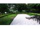 Community pool deck with lounge chairs surrounded by green landscaping at 2889 Columbus Ave, Clermont, FL 34715