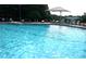 A full community pool with crystal clear water, plenty of seating, and ladders at 2889 Columbus Ave, Clermont, FL 34715