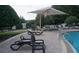 Community pool with lounge chairs, and large sun umbrella at 2889 Columbus Ave, Clermont, FL 34715