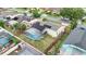 Aerial view of the home's backyard featuring a screened pool and solar panels on the roof at 2896 Picadilly Cir, Kissimmee, FL 34747