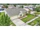 An aerial view of a well maintained home with lush green landscaping in a suburban neighborhood at 2896 Picadilly Cir, Kissimmee, FL 34747