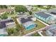 Aerial view of the backyard featuring a screened pool, solar panels, and a fenced yard at 2896 Picadilly Cir, Kissimmee, FL 34747