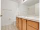 Bathroom featuring tiled floors, oak cabinets, and a spacious mirror at 2896 Picadilly Cir, Kissimmee, FL 34747