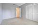 Neutral bedroom features gray walls, plush carpet, and built-in closet with paneled doors at 2896 Picadilly Cir, Kissimmee, FL 34747