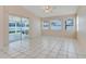 Bright Florida room featuring tile flooring, ceiling fan, and a sliding door for seamless indoor-outdoor flow at 2896 Picadilly Cir, Kissimmee, FL 34747