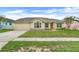 Charming single-story home featuring a well-maintained lawn and an attached two-car garage at 2896 Picadilly Cir, Kissimmee, FL 34747