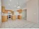 Well-lit kitchen equipped with an island, matching appliances, and tile flooring at 2896 Picadilly Cir, Kissimmee, FL 34747