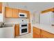 Bright kitchen with double oven, white countertops, and warm wood cabinetry for a cozy feel at 2896 Picadilly Cir, Kissimmee, FL 34747