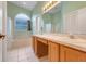 A bathroom with a double vanity, large mirror, and separate areas for bath and shower at 2896 Picadilly Cir, Kissimmee, FL 34747