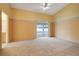 Carpeted main bedroom with a sliding glass door to the pool area and ensuite bathroom access at 2896 Picadilly Cir, Kissimmee, FL 34747