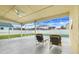 Screened patio with a ceiling fan and seating overlooking a pool with blue skies above at 2896 Picadilly Cir, Kissimmee, FL 34747
