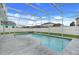 Beautiful pool in a screened-in patio with lush backyard grass and fencing at 2896 Picadilly Cir, Kissimmee, FL 34747