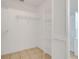 Neutral walk-in closet with tiled flooring and ventilated shelving and door at 2896 Picadilly Cir, Kissimmee, FL 34747
