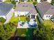 Aerial view showcases the home's backyard with a putting green, patio, lush landscaping, and privacy fence at 2928 Marlberry Ln, Clermont, FL 34714