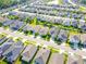 Aerial view showcasing a residential neighborhood with manicured lawns and modern homes at 2928 Marlberry Ln, Clermont, FL 34714