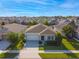 Aerial view of a single-story home in a residential neighborhood with lush green lawns at 2928 Marlberry Ln, Clermont, FL 34714