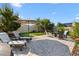 Outdoor living space features a patio, lounge chairs, a putting green, and privacy landscaping at 2928 Marlberry Ln, Clermont, FL 34714