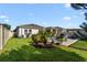 Well-maintained backyard featuring a patio, lush lawn, and vibrant landscaping at 2928 Marlberry Ln, Clermont, FL 34714