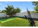 Backyard putting green with artificial turf, golf net, and pristine white fence at 2928 Marlberry Ln, Clermont, FL 34714