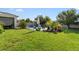 Lush backyard featuring green lawn and stone patio area with outdoor seating at 2928 Marlberry Ln, Clermont, FL 34714