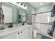 Bright bathroom featuring double sinks, framed mirrors, and a step-in shower with clear glass doors at 2928 Marlberry Ln, Clermont, FL 34714