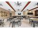 A modern common area for residents with tables, chairs, bar seating, and ceiling fans at 2928 Marlberry Ln, Clermont, FL 34714