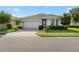 Charming single-story home with a well-manicured front lawn and attached two-car garage at 2928 Marlberry Ln, Clermont, FL 34714