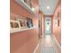 Hallway showcasing light wood floors, decorative shelves, and a view of the front door at 2928 Marlberry Ln, Clermont, FL 34714