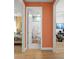 Hallway featuring views of the bedroom and bathroom with white trim and wood-look flooring at 2928 Marlberry Ln, Clermont, FL 34714