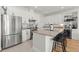 Modern kitchen with stainless steel appliances, granite countertops, and a center island with bar seating at 2928 Marlberry Ln, Clermont, FL 34714