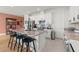 Bright kitchen features white cabinets, stainless appliances, granite counters, and a large center island with bar seating at 2928 Marlberry Ln, Clermont, FL 34714