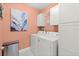 Well-organized laundry room with modern appliances, storage cabinets, and stylish decor at 2928 Marlberry Ln, Clermont, FL 34714