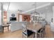 Open-concept living and dining area with hardwood floors, modern lighting, and access to a spacious kitchen at 2928 Marlberry Ln, Clermont, FL 34714