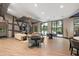 Spacious lounge area featuring modern sofas, tables, and large windows offering outdoor views at 2928 Marlberry Ln, Clermont, FL 34714