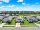 Aerial view of a neighborhood with well-manicured lawns and a beautiful lake backdrop at 31760 Broadwater Ave, Leesburg, FL 34748