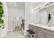 Bathroom featuring a double vanity with stone countertops, decorative mirror, and a separate shower area at 31760 Broadwater Ave, Leesburg, FL 34748