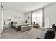 Bright main bedroom features neutral decor, a comfortable bed, and plenty of space to relax and unwind at 31760 Broadwater Ave, Leesburg, FL 34748