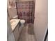 Bathroom with a tile floor, vanity, toilet, and shower-tub combo with a curtain at 3306 Sandy Shore Ln, Kissimmee, FL 34743