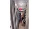 Walk in closet for storage with clothing and personal items on the shelves and racks at 3306 Sandy Shore Ln, Kissimmee, FL 34743