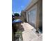 Exterior view of the side of the home with trash bins and landscaping at 3306 Sandy Shore Ln, Kissimmee, FL 34743