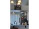 Open kitchen view with modern appliances, cabinets and a large dining table at 3306 Sandy Shore Ln, Kissimmee, FL 34743