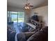 Cozy living room with lake view, comfortable sofa, and large sliding glass door at 3306 Sandy Shore Ln, Kissimmee, FL 34743