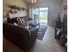 Spacious living room with lake view and comfortable sofa at 3306 Sandy Shore Ln, Kissimmee, FL 34743