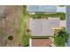 Overhead view of home with manicured landscape and mature trees next to the street at 33417 Pennbrooke Pkwy, Leesburg, FL 34748