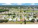 Expansive aerial of a residential community adjacent to a golf course with several ponds at 33417 Pennbrooke Pkwy, Leesburg, FL 34748
