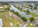 An aerial view of a community pond with RV parking and houses for a relaxed lifestyle at 33417 Pennbrooke Pkwy, Leesburg, FL 34748