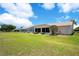 Exterior rear view shows the lawn and enclosed lanai at 33417 Pennbrooke Pkwy, Leesburg, FL 34748