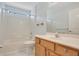 Well-lit bathroom with vanity, mirror, shower, and tub at 33417 Pennbrooke Pkwy, Leesburg, FL 34748